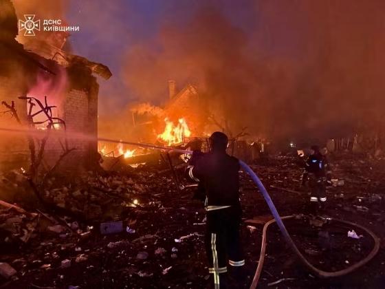 Bombeiros tentam apagar um incêndio após um ataque russo na região de Kiev em 25 de maio de 2025.